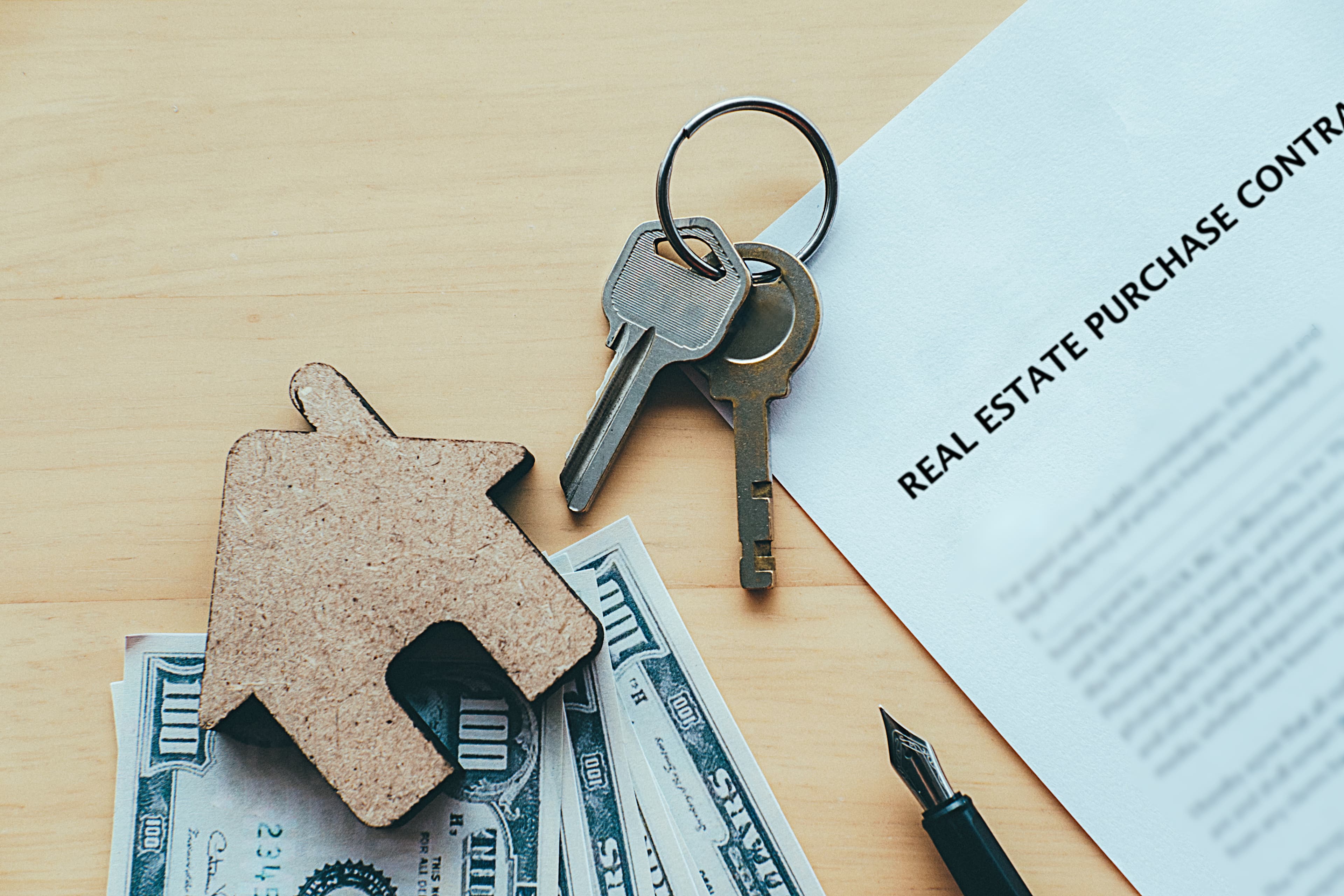 Property contract with house keys and rental income