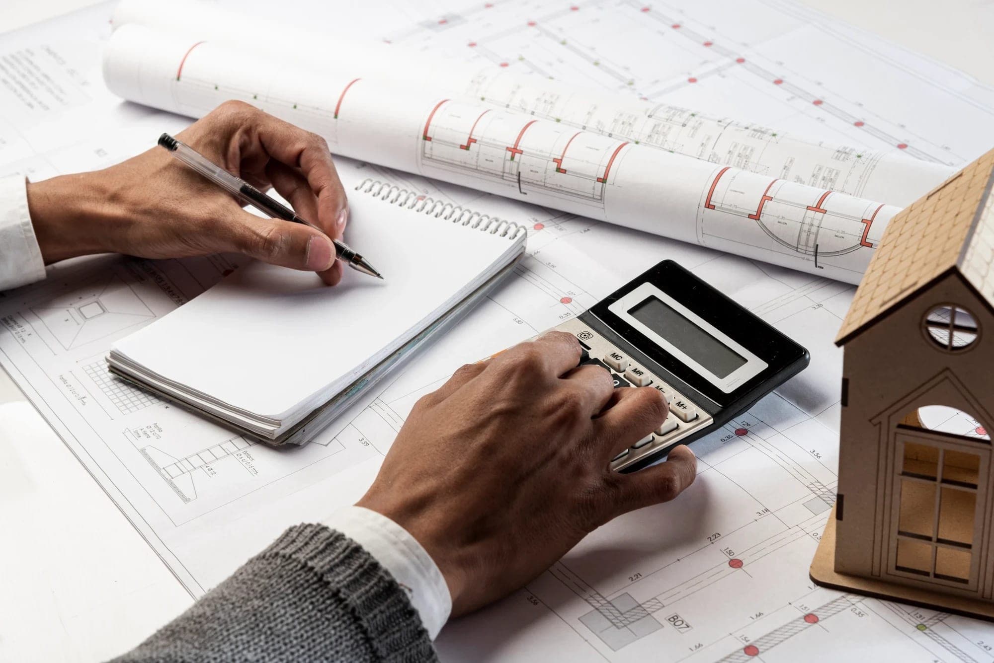 Advisor reviewing property plans and figures at a desk