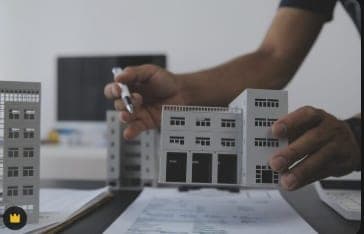 Architect arranging scale models of managed buildings