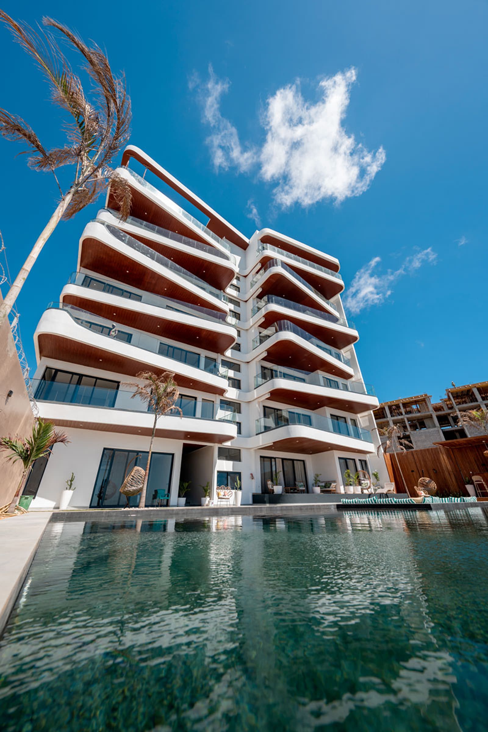 Poolside view of a managed residential tower